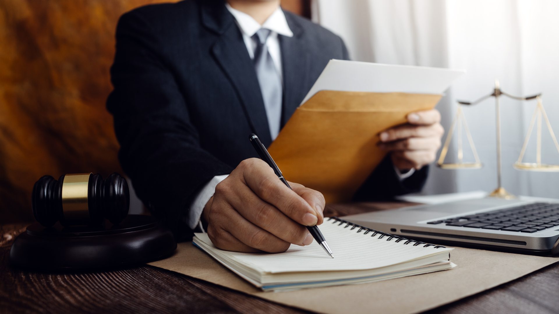 justice and law concept.Male judge in a courtroom on wooden table and Counselor or Male lawyer working in office. Legal law, advice and justice concept.