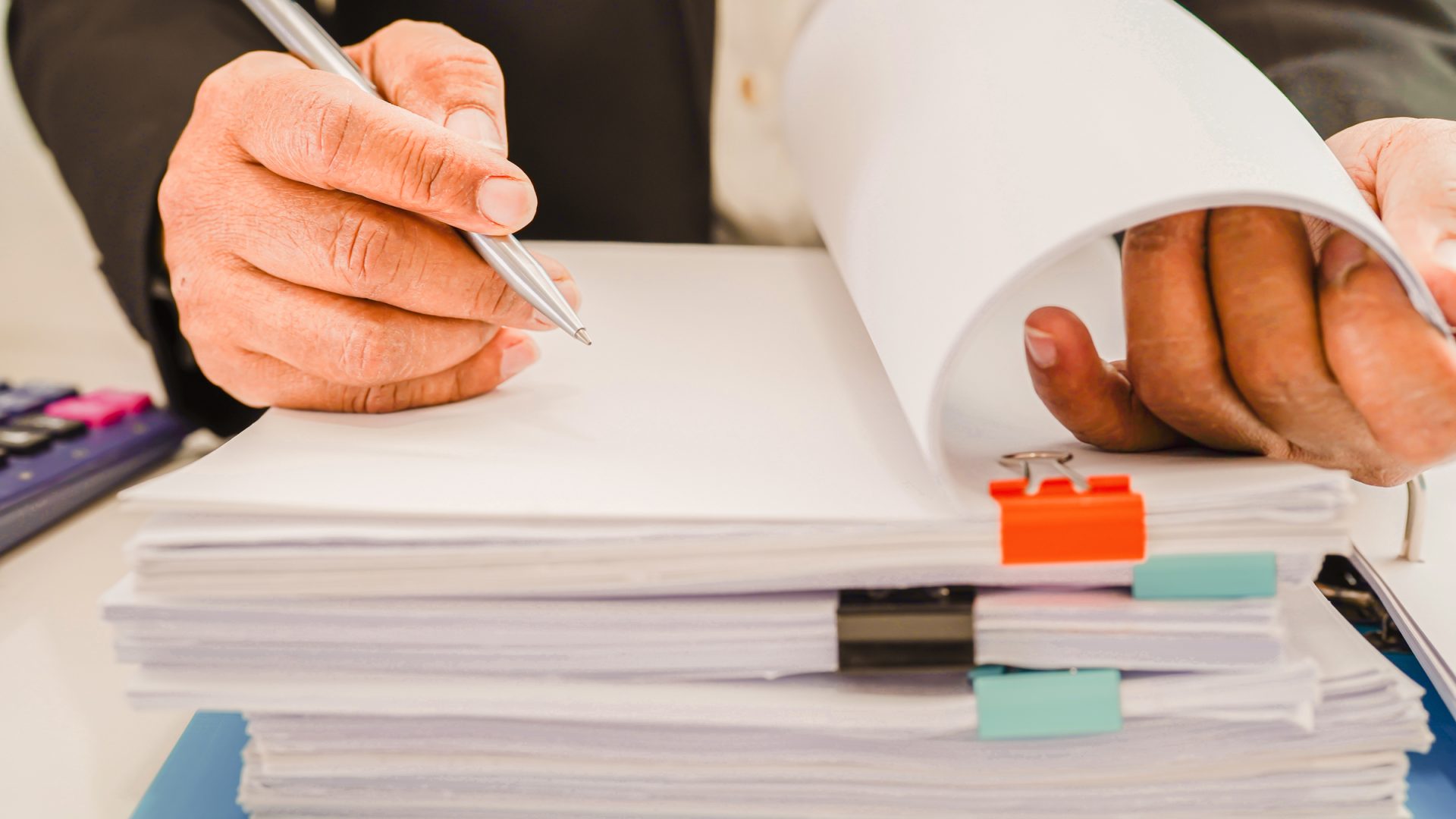 Businessman working and prepare paperwork report data to analysis information in file binder at office.